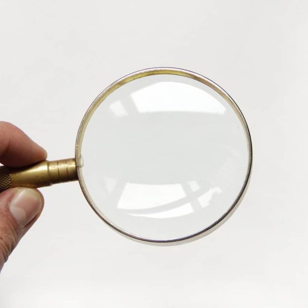 holding a magnify glass